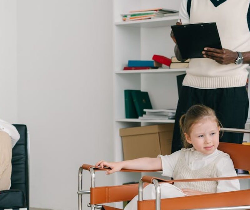 Kids in center-based therapy looking calm in a sunlit room with their dedicated teacher.