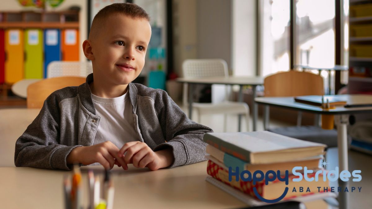 A blonde boy with autism sits calmly in a classroom, appearing self-assured and composed.
