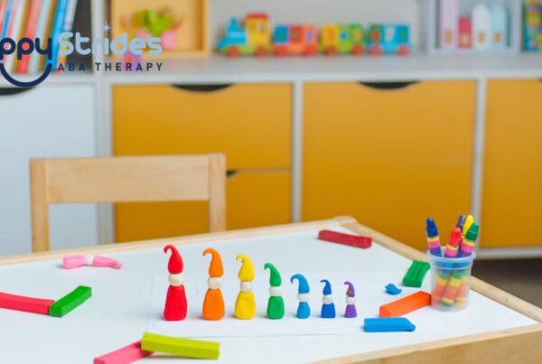A row of plastic, colored gnomes arranged by height on a white table in a brightly lit playroom.