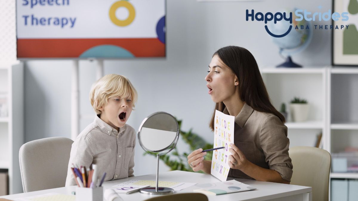 A female therapist guides a young boy in prompt therapy in a bright white room, illustrating autism support and intervention.