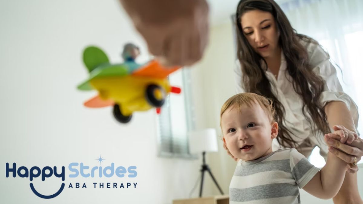A mother guides her toddler through a physical activity during at-home autism therapy.