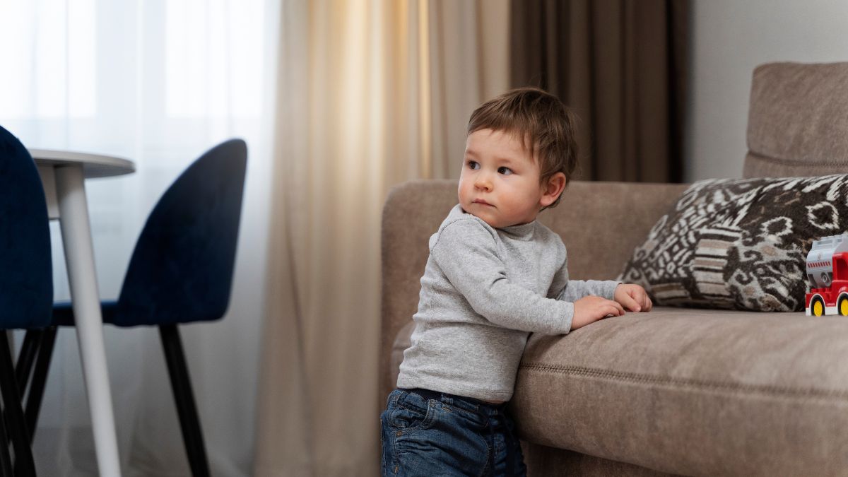 Boy in a living room preparing for a transition, organizing himself before moving to the next activity.