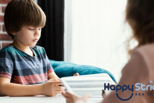 A young boy with autism works on an executive functioning assessment while being guided by his therapist.