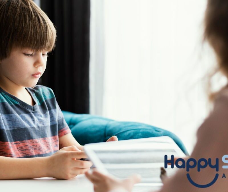 A young boy with autism works on an executive functioning assessment while being guided by his therapist.