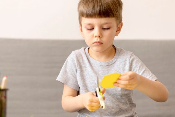 Boy accomplishing a craft activity, illustrating problem-solving skills often supported in autism.