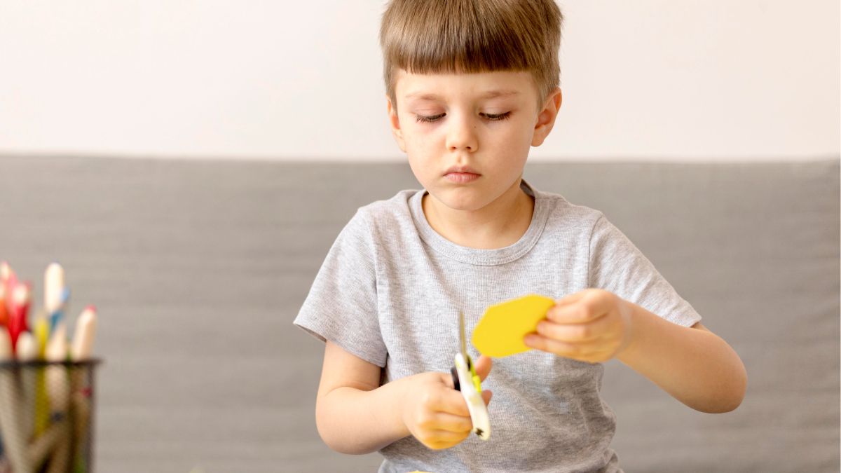 Boy accomplishing a craft activity, illustrating problem-solving skills often supported in autism.